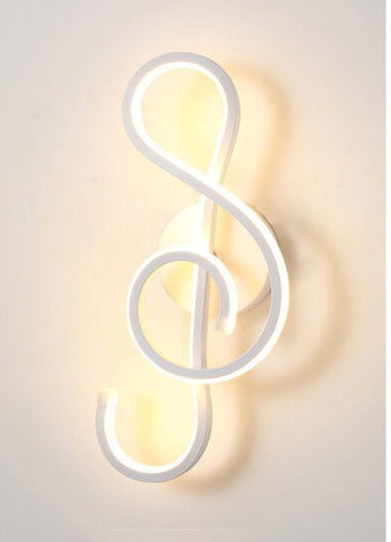 The Note Curved LED Wall Sconce in matte white, warm light