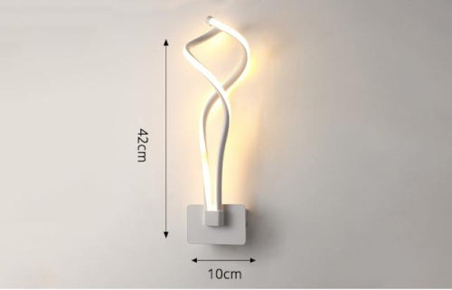 Sarmak Sculptural LED Wall Sconce in matte white mounted on wall